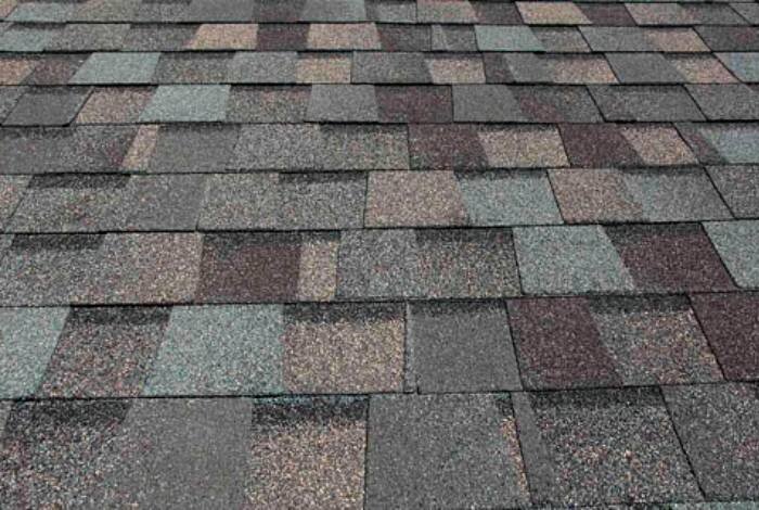 A beautifully crafted roof featuring an array of colorful shingles, exemplifying the quality work of Alom Builders.